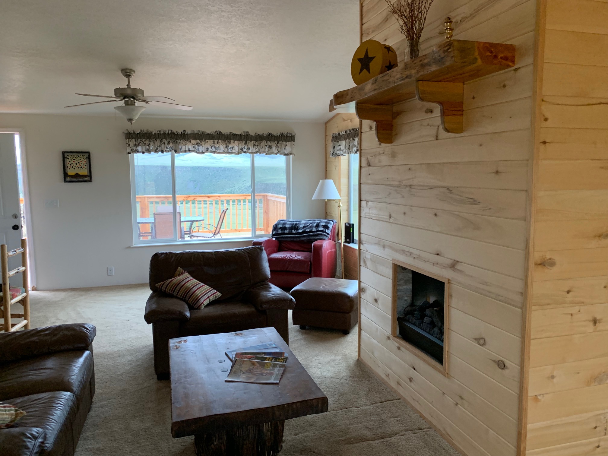 Living room upstairs with back deck overlooking the river